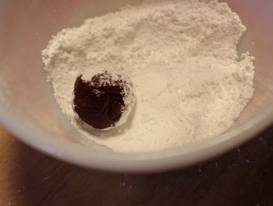 Roll balls of dough in powdered sugar.