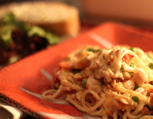 Seafood Newburg with salad and ciabatta bread.