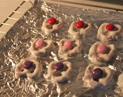 Pretzels dipped into white chocolate and decorated.