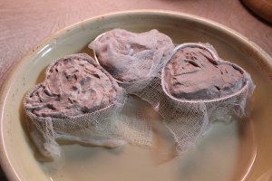 Fill molds and cover with cheesecloth.