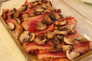 Bacon and mushrooms on top of the chicken.