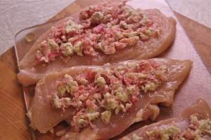 Spread a small amount of filling on each chicken breast.