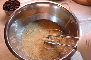 Beating in the eggs.