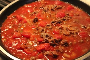Add the browned beef and water to the pan.