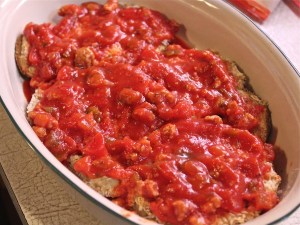 A layer of sauce in the bottom of the dish, then eggplant, then more sauce.