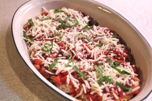 Sprinkle with grated mozzarella and chopped basil.