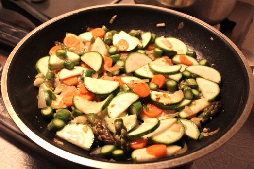Sauteing all the vegetables together.
