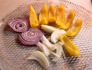 Prepare the vegetables for the grill. 
