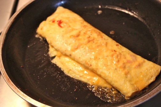 Fold the omelet in thirds and let the heat melt the cheese filling.