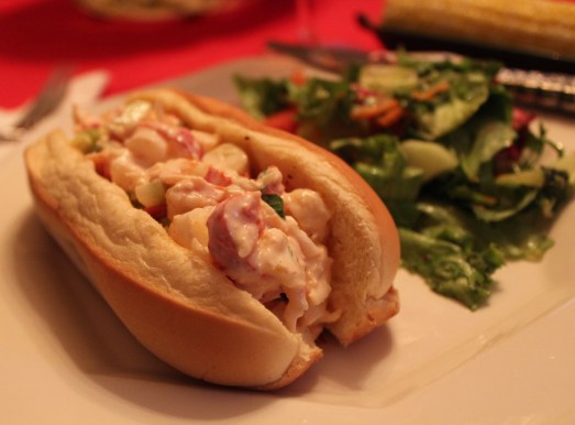 A toasted bun, filled to the top with luscious lobster salad.
