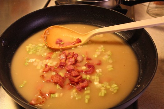 Add chicken broth, bacon and scallions.