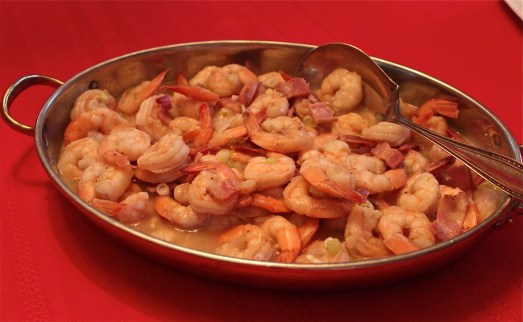Shrimp in gravy in a serving bowl.
