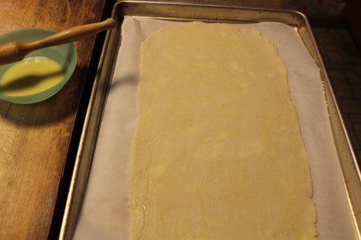 Bottom layer of pastry, brushed with egg wash.