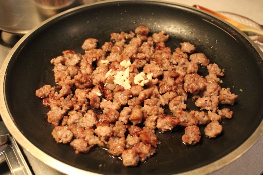 Sausage crumbled and brown, add in minced garlic.