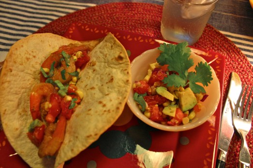 Shrimp tacos with corn and avocado salsa. 