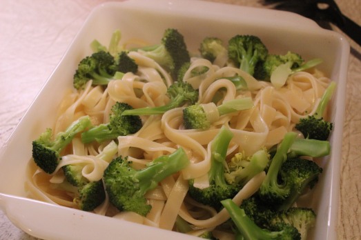 Place cooked fettuccine and  broccoli in a serving dish.