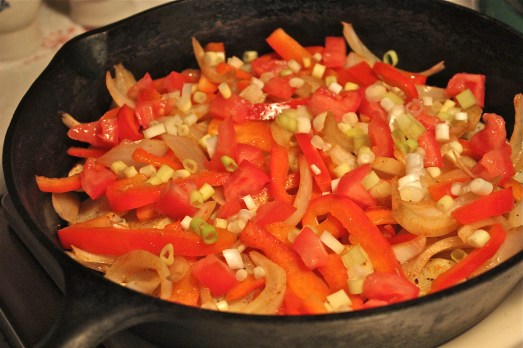 Pile on sautéed peppers and onions.
