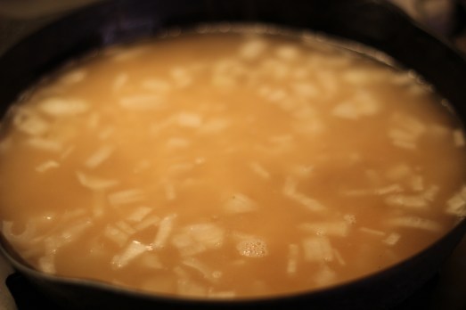 Add the wine and chicken broth all at once.