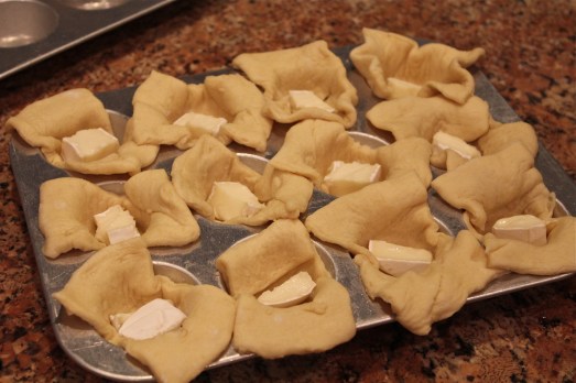 Put a square of dough in each cup and add a piece of brie.