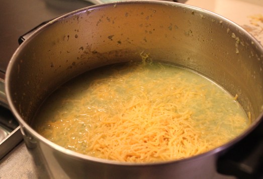   Add in the grated cheese and stir to melt.