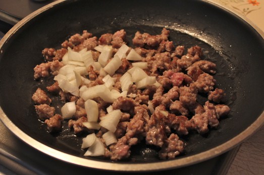 Cooking up the sausage and onion.