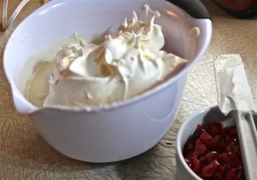 Fold in whipped cream and chopped cherries.