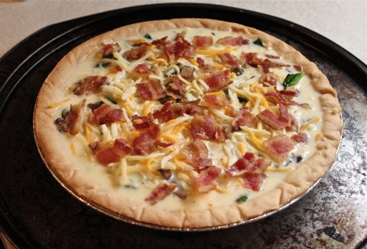 Sprinkle crumbled bacon over all, and pour in milk mixture.