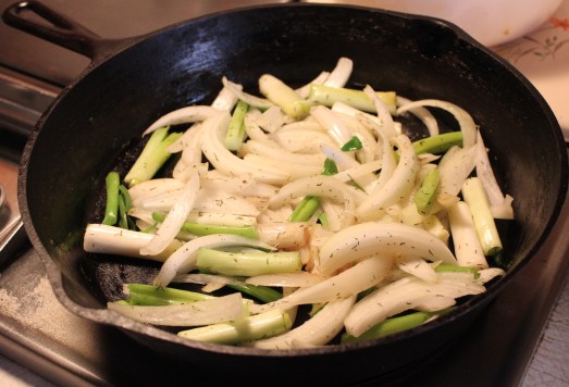 Stir frying the onions and green onions.