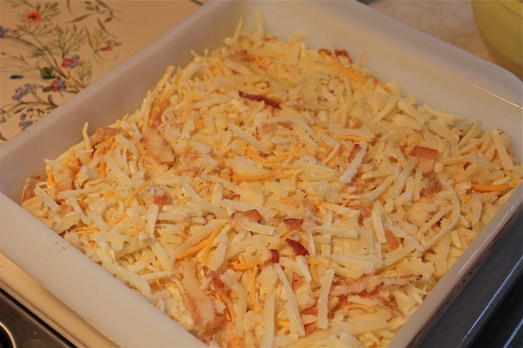 Spread potatoes, bacon and cheese evenly in bottom of baking dish,