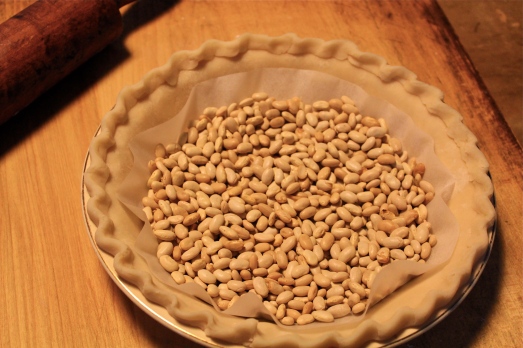 Fill with dried beans or pie weights prior to blind baking.