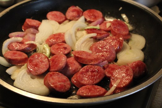Browning the sausage with onions.